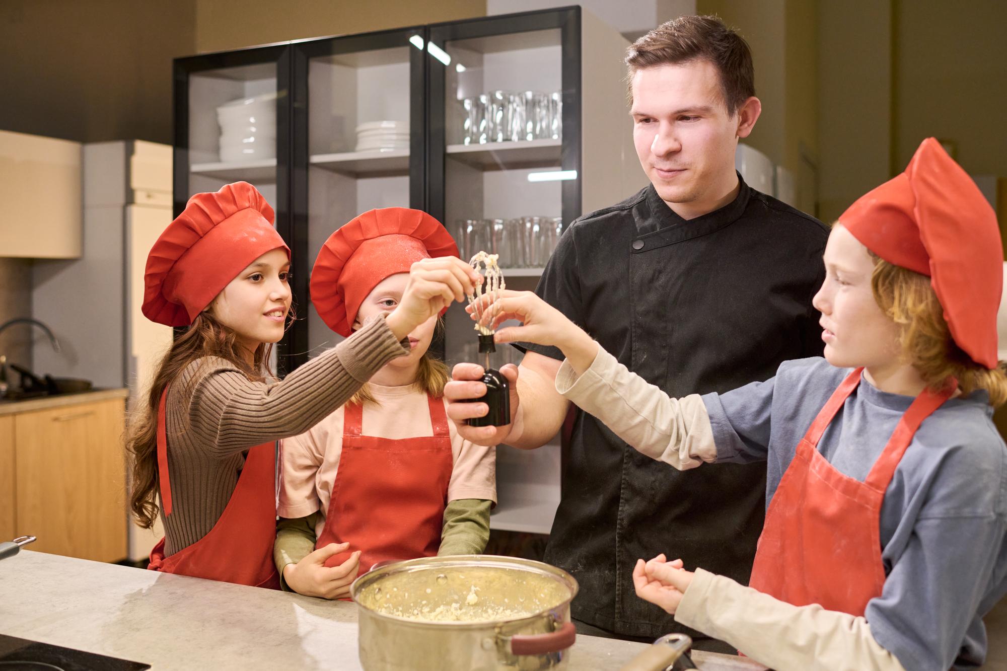 Chef explaining sauce technique to students
